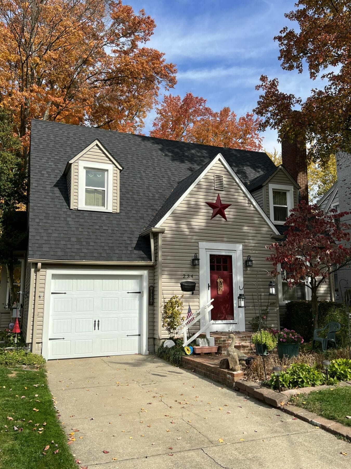 New steep roof on home with red door